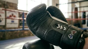 Graphic showing the anatomically correct attached thumb design of a sparring glove to prevent injury.