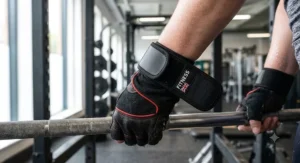 Affordable gym gloves for weightlifting featuring an integrated adjustable hook-and-loop wrist support strap.