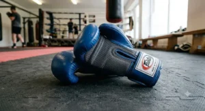 Close-up of Fairtex breathable mesh boxing gloves in blue, showing the ventilated palm for heat regulation.