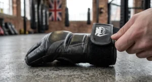 Detailed view of the hook and loop wrist strap on a grappling glove providing secure support during intense groundwork and sparring.