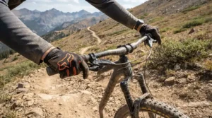 Showing superior handlebar control with the best MTB gloves for downhill on a loose gravel track.
