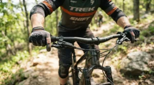 Close-up of a cyclist wearing comfortable road cycling gloves for beginners while gripping handlebars on a tarmac lane.