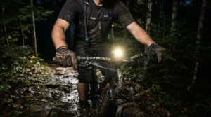 Night-time mountain biking session illuminated by a helmet light, wearing reflective full finger MTB gloves