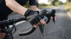 Hands resting on handlebars wearing padded long finger road cycling gloves during a British sportive