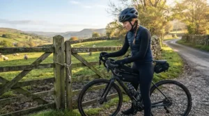 Cyclist adjusting gear with waterproof long finger road cycling gloves on a chilly spring morning
